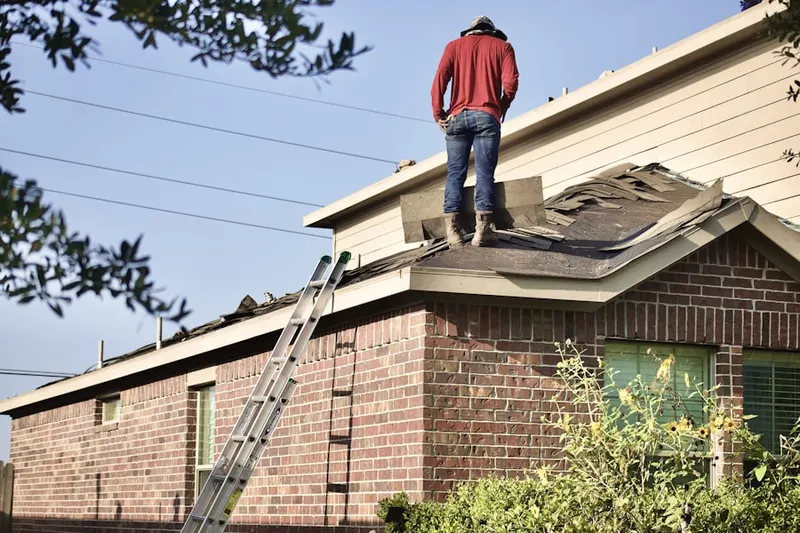 Professional roofer working on a residential roof in Little Hollow